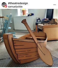 a cardboard boat sitting on top of a rug