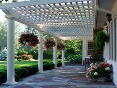 an outdoor covered patio with potted plants and flowers