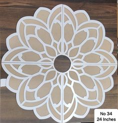 a cut out paper flower on top of a wooden board with the words no 34 inches below it