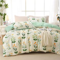 the comforter is made up with green and yellow flowers