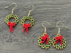 three pairs of beaded christmas wreaths on wooden table with red bows and green beads