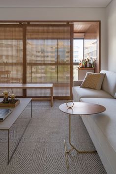 a living room with two couches and a coffee table in front of the window