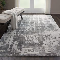 a large rug with an abstract design in grey and white