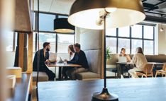 people sitting at tables in an office setting