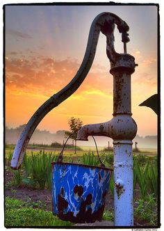 an old rusty water faucet and bucket with the words, come hell or high water