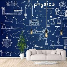 a couch sitting in front of a blue wall with physics drawings on it