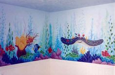 this bathroom has underwater themed walls and is painted with blue, green, pink and orange colors