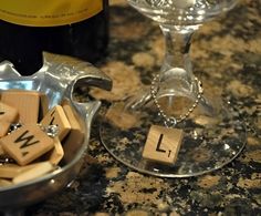 scrabble tiles spelling out the word love in front of a wine bottle