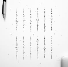 a white wall with many different designs on it and a pen next to the wall