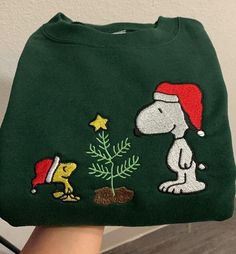 Get into the holiday spirit with our Snoopy Christmas embroidered sweatshirt. Featuring the beloved Peanuts character Snoopy, this festive sweatshirt is perfect for spreading cheer and warmth during the holiday season. Product Features: Materials: Crafted from premium, soft fabric, this sweatshirt offers both comfort and style for your festive celebrations. Design: The front showcases intricately embroidered Snoopy in a charming Christmas scene, making this sweatshirt a delightful addition to yo Ugly Christmas Sweaters Aesthetic, Christmas Sweaters Cute, Xmas Sweaters, Christmas Merch, Christmas Sweaters Aesthetic, Christmas Pullover, Christmas Crewneck Sweatshirt, Cute Christmas Sweaters, Vintage Christmas Sweater