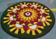 a colorful flower arrangement on the ground in front of a person walking down the street