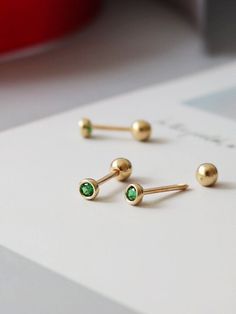 🍃--Details-- Handmade item Materials: Solid Gold (no gold filled or gold plated) Gold Kt: 14K Gemstone: Emerald  Gem colour:Green Style: Minimalist & Modern & Classic Made to Order 🍃--Description-- ❤️All components of the Earrings are genuine 14ct Gold. ❤️14K Solid Gold Emerald Green Gemstone Tiny Stud Earrings, 14K Real Gold Emerald ball end piercing, Cartilage Helix 2nd/3rd earlobe Piercings 🍃Earrings Features  ✪ 14k Solid Gold  (no gold filled or gold plated) ✪ AAA Grade Lab Grown Green Paraiba Tourmaline ✪ Earring size : 2.8*2.8mm ✪ Thickness: 0.8 mm ✪ Gold Colour : Yellow Gold ✪ Made to Order  --Others Information--  🔧Making:  WIQEE Jewels' pieces made to order. Please allow 4 - 8 business days for manufacturing. Need it sooner? Just ask and we will let you know if it's possible o Helix Studs, Earlobe Piercings, Piercings Earrings, Gold Earrings Models, Piercing Cartilage, Geometric Elements, Emerald Gem, Wrist Jewelry, Tourmaline Earrings