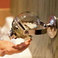 a person is opening a door with a glass ball on the handle and holding it in their hand