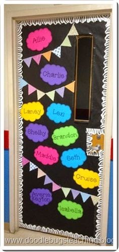 a classroom door decorated with colorful paper decorations