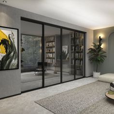 a living room filled with furniture and a painting on the wall next to glass doors