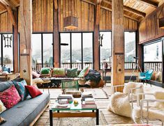 a living room filled with furniture and lots of windows