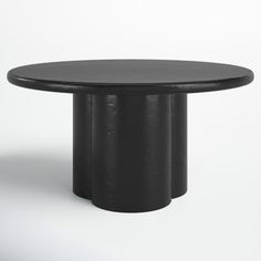 a black round table with three columns on the top and one column at the base