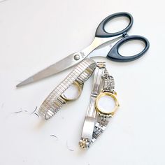 two pairs of scissors sitting next to each other on top of a white countertop