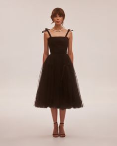 This cute off-the-shoulder cocktail midi gown is made of delicate tulle fabric. Featuring a straight neckline, a puffy tulle midi skirt with bow ties, and a lace-up closure on the back. Details: Material: Tulle Fabric Composition: 100% polyester Sleeves style: Tie-straps Silhouette: Princess silhouette Skirt length from waist: 35.4 inches / 90 cm Dress weight: 1.7 lbs / 0.8 kg Neckline: Straight Back: Lace-up corset Built-in cups Lining: Black full-length flared underskirt Model is 180cm / 84-62 Midi Tulle Dress, Milla Dresses, Black Tulle Dress, Skirt With Bow, Midi Gowns, Homecoming Outfits, Dress Weights, Tulle Midi Skirt, Black Tulle