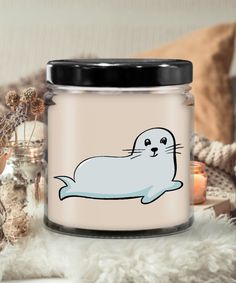 a glass jar with an image of a seal on the front and bottom, surrounded by other items