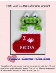 a cross stitch frog sitting on top of a christmas stocking with the words i love frogs