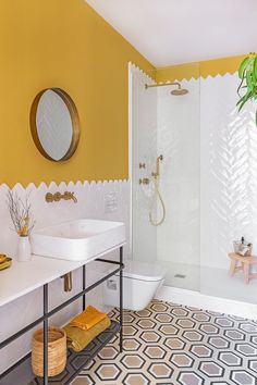 a bathroom with yellow walls and white fixtures