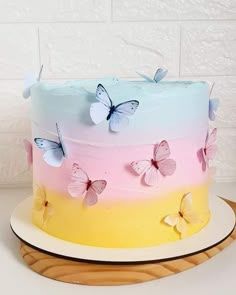 a multicolored cake with butterflies on it