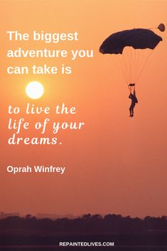 a person flying through the air while holding onto a parasail in front of a sunset