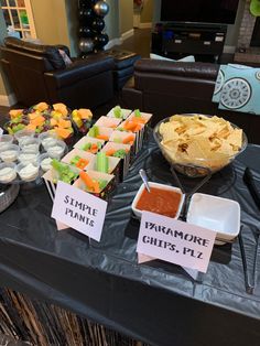 a table topped with lots of different types of food and desserts on top of it