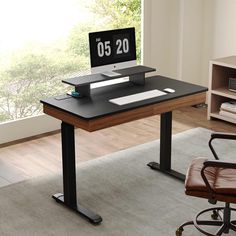 a computer desk with a clock on it