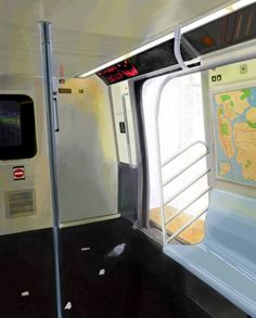 the inside of a train with its door open and map on the wall next to it