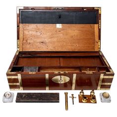 an old wooden trunk with brass trimmings and other items in it on a white background