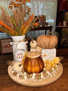 a wooden plate topped with pumpkins and other decorations