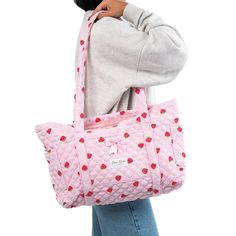 Our Strawberry Tote Bag is a cozy and stylish bag that combines every-day convenience with a classic design. It features 3 exterior pockets, and a bow for an added touch of elegance.   The quilted exterior features a beautiful strawberry-themed pattern, complemented by a classy pink gingham interior.    Ideal for carrying books and groceries, or hauling beach gear and gym clothes, this bag is a must have for anyone who values versatility.   Size: 16.5" x 12" x 5" (42cm x 30cm x 12cm) Trendy Strawberry Print Bag At Affordable Price, Trendy Cheap Bags With Strawberry Print, Cheap Strawberry Print Summer Bags, Inexpensive Rectangular Bag With Strawberry Print, Gingham Interior, Strawberry Tote Bag, Mini Makeup Bag, Strawberry Girl, Cute School Stationary