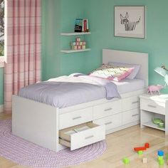 a child's bedroom with green walls and white furniture