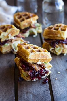 two waffle sandwiches stacked on top of each other with cranberry toppings