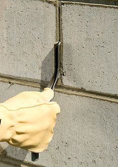 a pair of gloves hanging on the side of a building