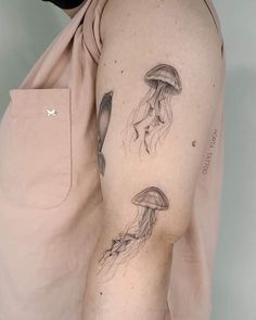 a man's arm with a jellyfish tattoo on the left side of his body