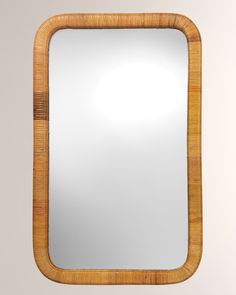 a mirror that is made out of wood and has a rattan border around it