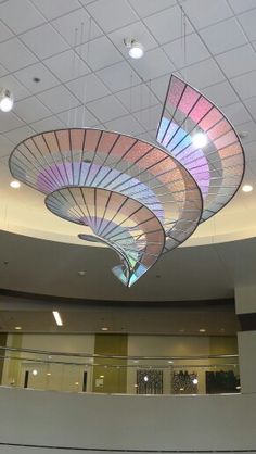 the ceiling is decorated with colorful lights and circular shapes in an office building or conference room