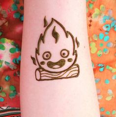 a person with a tattoo on their arm that has a drawing of a cartoon character