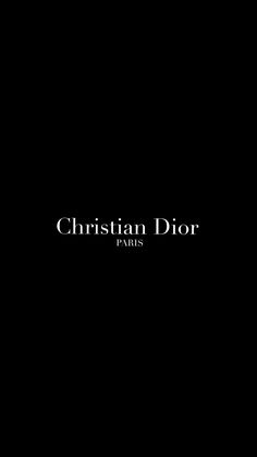 the christian dior logo is shown in black and white on a dark background,