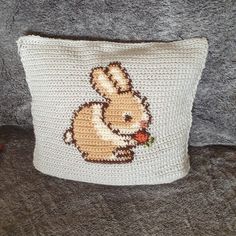 a crocheted bunny pillow sitting on top of a couch