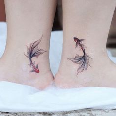 two goldfish tattoos on both legs