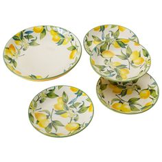 four plates with lemons and leaves painted on them