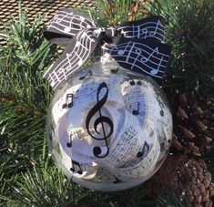 an ornament with musical notes on it and a pine cone next to it