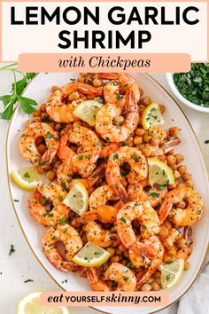 lemon garlic shrimp with chickpeas is shown on a white plate and garnished with parsley