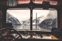 the inside of a boat with mountains in the background