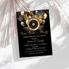 a black and gold new year's eve party card with an alarm clock on it