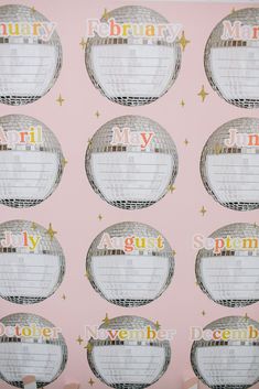 a pink wall with several round labels on it that say,'happy new year '